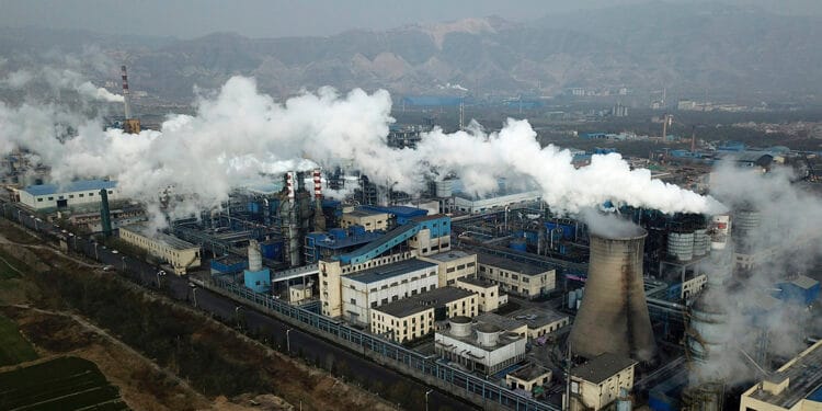 FILE - In this Nov. 28, 2019 file photo, smoke and steam rise from a coal processing plant in Hejin in central China's Shanxi Province. Officials from around the globe begin three weeks of grueling online climate talks organized by the U.N. climate office in Bonn, Germany. The talks will involve grappling with a number of thorny climate and political issues, without the benefit of face-to-face meetings, due to pandemic restrictions. (AP Photo/Sam McNeil, File)